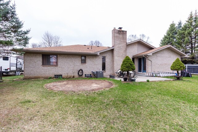 46498 Houghton Dr, Shelby, MI 48315 - back of house with central AC, a patio area, a lawn, a chimney, and brick siding