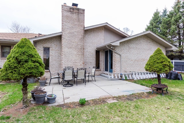 46498 Houghton Dr, Shelby, MI 48315 - rear view of house featuring a chimney, a patio area, brick siding, an outdoor fire pit, and a yard