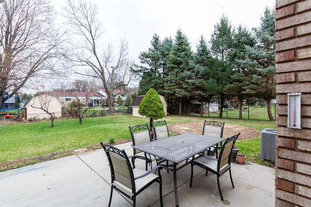 46498 Houghton Dr, Shelby, MI 48315 - view of patio with central AC unit, a fenced backyard, outdoor dining area, and an outdoor structure