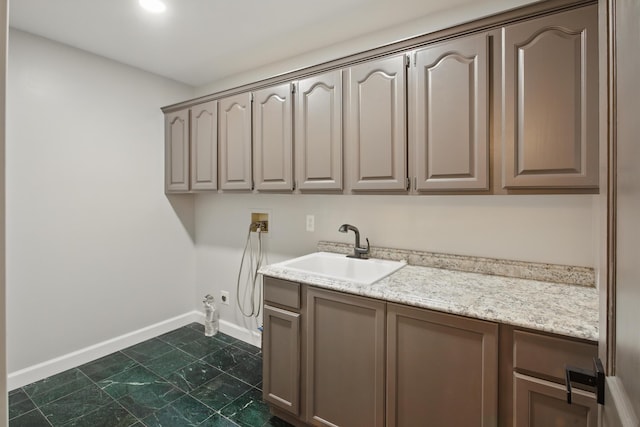 4489 Cranbrook Trl, Orchard Lake, MI 48323 - laundry room featuring baseboards, washer hookup, a sink, gas dryer hookup, and cabinet space