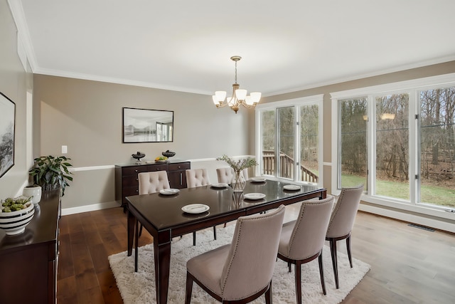 4489 Cranbrook Trl, Orchard Lake, MI 48323 - dining area with a notable chandelier, baseboards, ornamental molding, visible vents, and wood finished floors