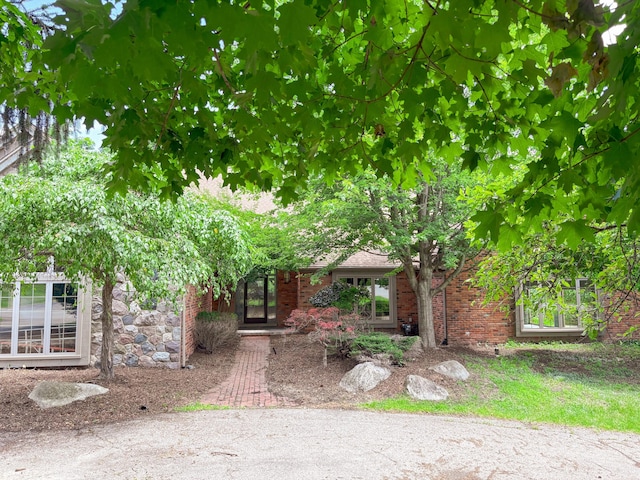4489 Cranbrook Trl, Orchard Lake, MI 48323 - view of property hidden behind natural elements featuring brick siding