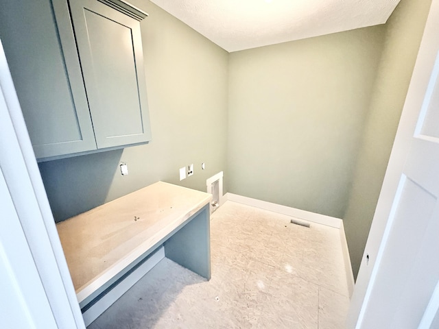 8284 Kettle Oak Dr, Alto, MI 49302 - laundry area featuring cabinet space, baseboards, and washer hookup