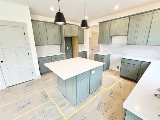8284 Kettle Oak Dr, Alto, MI 49302 - kitchen featuring decorative backsplash, a center island, light wood-style flooring, decorative light fixtures, and recessed lighting