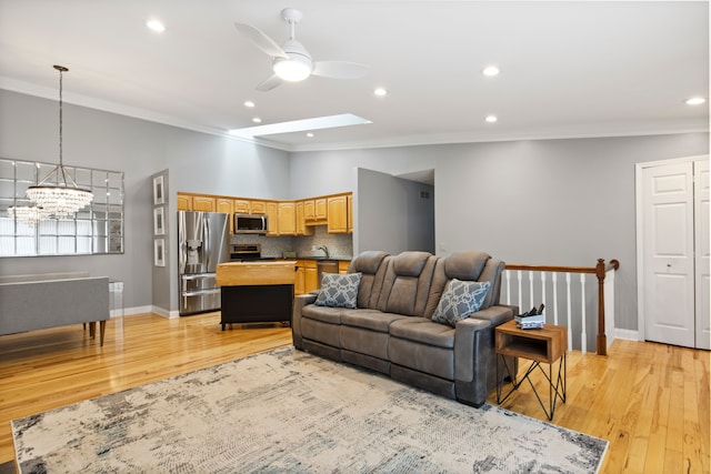 22068 Edgewater, Novi, MI 48375 - living room featuring crown molding, baseboards, ceiling fan with notable chandelier, and light wood finished floors