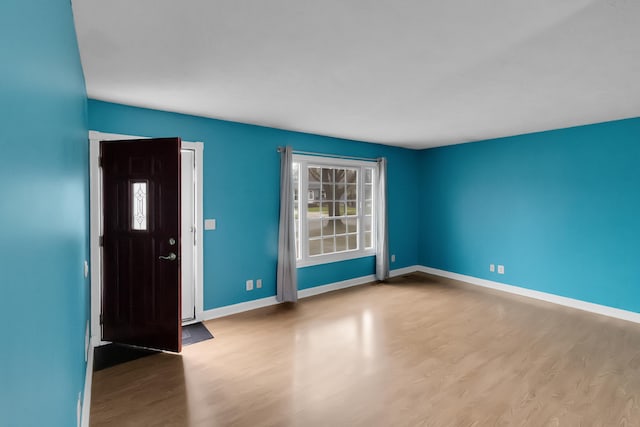 interior space featuring wood finished floors and baseboards
