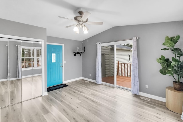 foyer entrance with wood finished floors, ceiling fan, baseboards, and vaulted ceiling