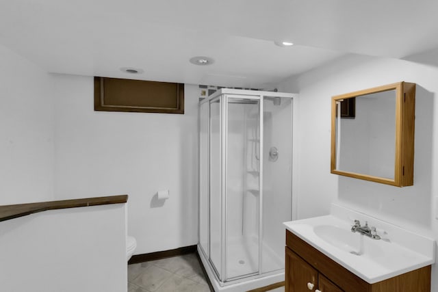 full bath with tile patterned flooring, toilet, a stall shower, and vanity