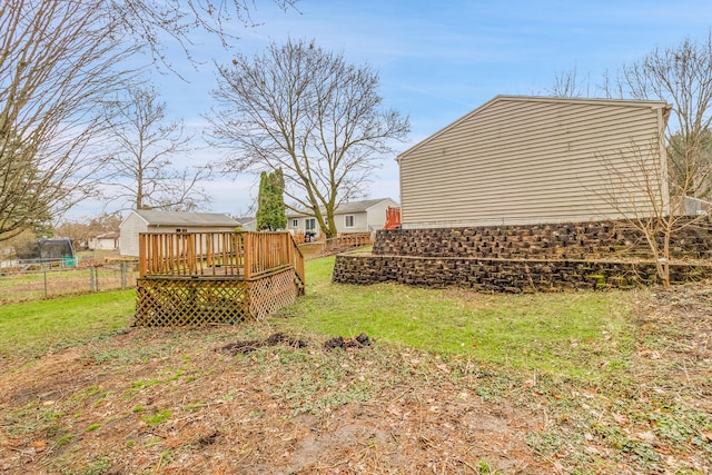 view of yard featuring fence and a deck