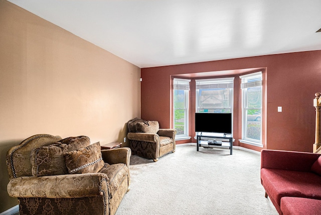 living room featuring carpet and baseboards