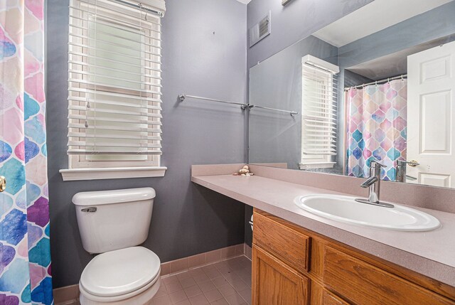 full bath featuring tile patterned flooring, vanity, toilet, baseboards, and curtained shower