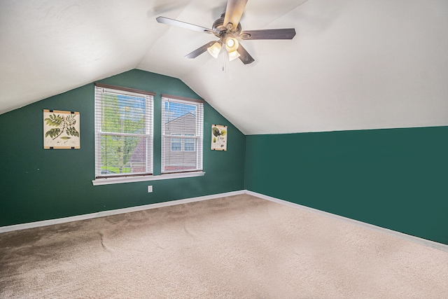 bonus room with carpet, vaulted ceiling, baseboards, and a ceiling fan