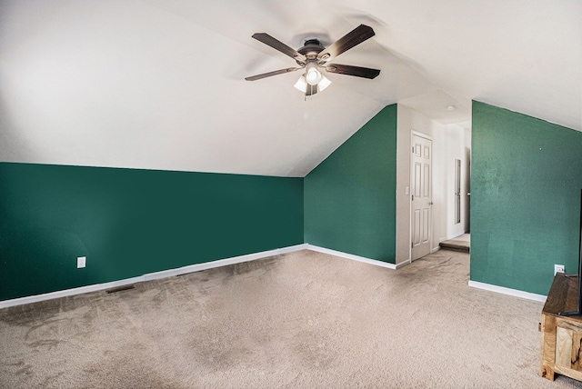 additional living space featuring carpet floors, a ceiling fan, baseboards, and vaulted ceiling