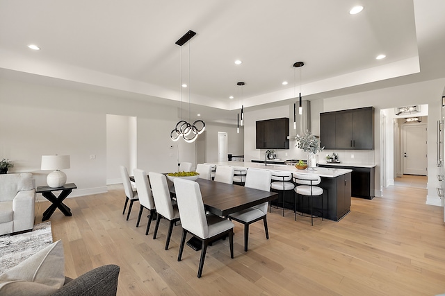 49351 Villa Dr, Novi, MI 48374 - dining area with light wood-type flooring, recessed lighting, a raised ceiling, and baseboards