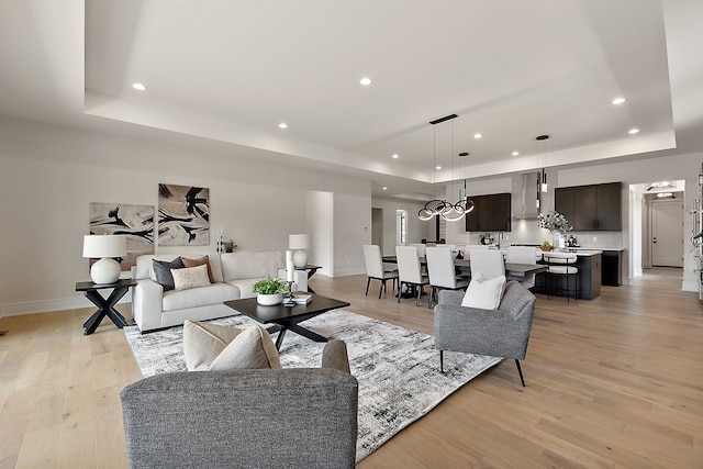 49351 Villa Dr, Novi, MI 48374 - living area with a tray ceiling, recessed lighting, baseboards, and light wood-style flooring