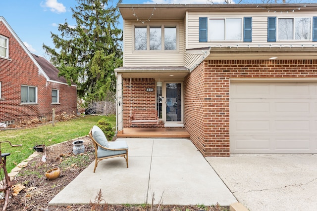 view of front of house with a garage, a front yard, and brick siding