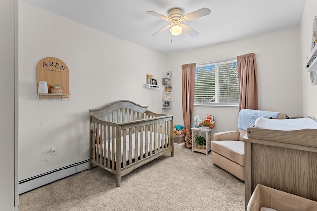 carpeted bedroom with a baseboard heating unit and ceiling fan