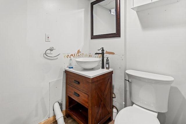 half bathroom featuring toilet and vanity
