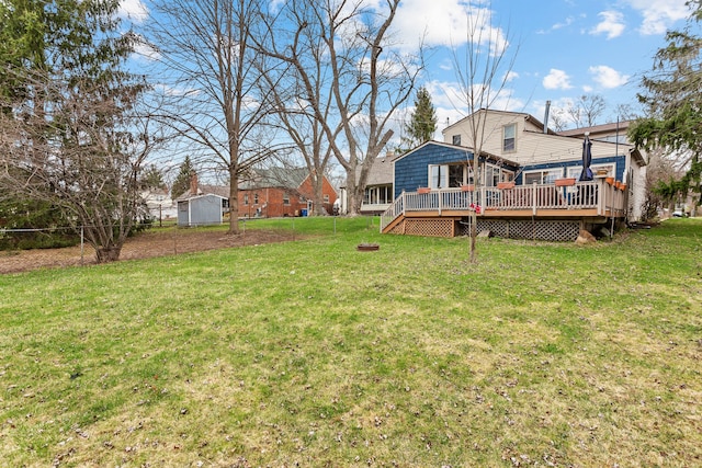 view of yard with a wooden deck and fence