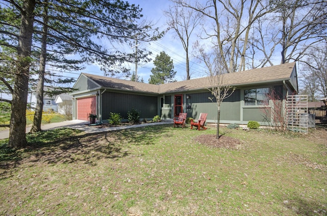 single story home featuring a front yard, driveway, and an attached garage