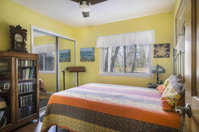 bedroom with a closet, a ceiling fan, and wood finished floors