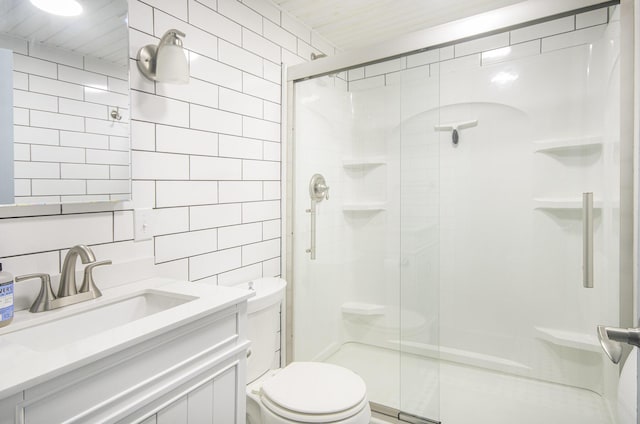 full bath featuring tile walls, toilet, a shower stall, vanity, and decorative backsplash
