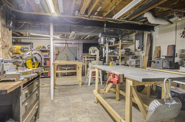 unfinished below grade area featuring a workshop area and electric panel