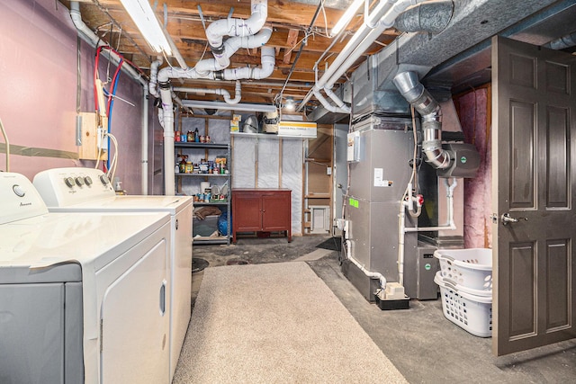 unfinished basement featuring washer and dryer and heating unit