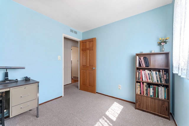 carpeted home office with visible vents and baseboards