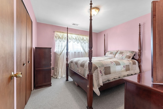 carpeted bedroom featuring visible vents