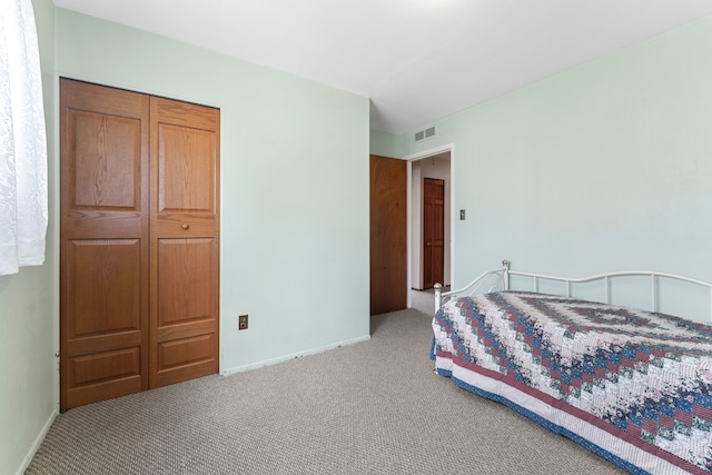 bedroom with carpet flooring, visible vents, and baseboards