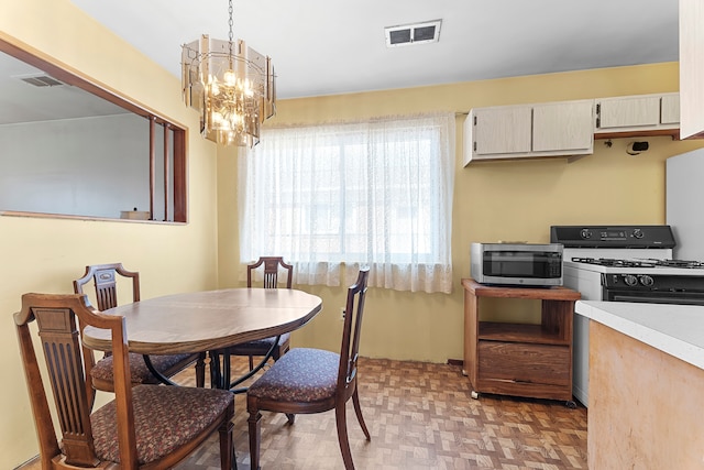 dining space with a chandelier and visible vents
