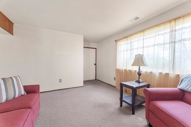living area with light carpet and visible vents