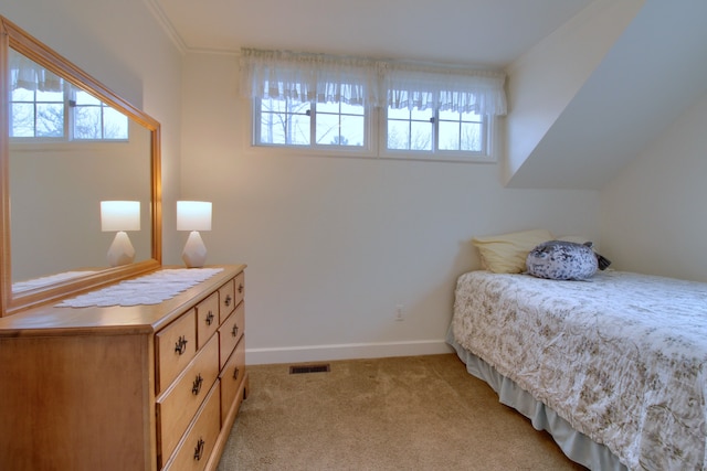 bedroom with visible vents, baseboards, and light carpet