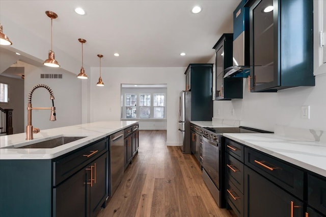 1459 Edison St, Detroit, MI 48206 - kitchen with recessed lighting, light wood-style flooring, a kitchen island with sink, stainless steel appliances, and a sink