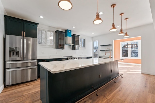1459 Edison St, Detroit, MI 48206 - kitchen featuring a sink, wall chimney range hood, stainless steel refrigerator with ice dispenser, and plenty of natural light