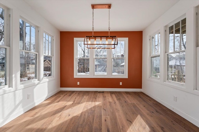 1459 Edison St, Detroit, MI 48206 - unfurnished dining area featuring light wood-style floors, baseboards, and an inviting chandelier