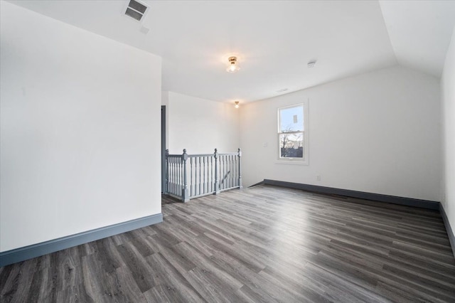 1459 Edison St, Detroit, MI 48206 - additional living space featuring visible vents, baseboards, vaulted ceiling, and wood finished floors
