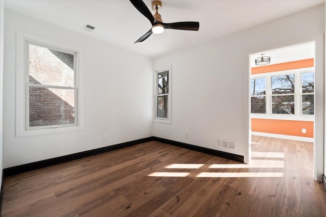1459 Edison St, Detroit, MI 48206 - spare room featuring visible vents, plenty of natural light, and hardwood / wood-style floors