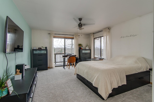 carpeted bedroom featuring access to exterior and ceiling fan