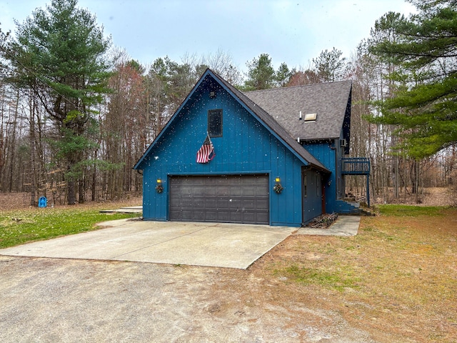 rustic home with a garage, roof with shingles, concrete driveway, board and batten siding, and a front lawn