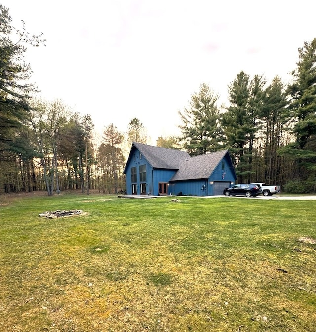 view of green lawn featuring a garage