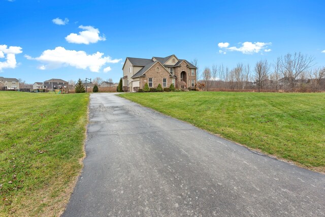 316 Lenox Ln, Brighton, MI 48114 - view of front facade with aphalt driveway, a garage, and a front lawn