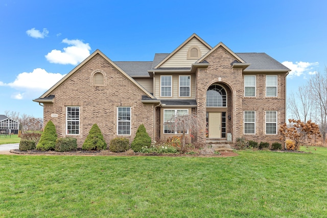 316 Lenox Ln, Brighton, MI 48114 - view of front of property with brick siding, a front lawn, and a shingled roof