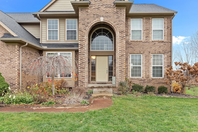 316 Lenox Ln, Brighton, MI 48114 - view of front of home featuring brick siding, a front lawn, and roof with shingles