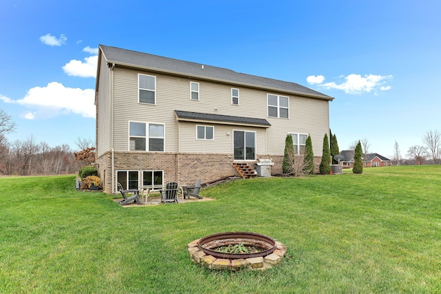 316 Lenox Ln, Brighton, MI 48114 - rear view of house featuring a fire pit, entry steps, a yard, a patio area, and brick siding