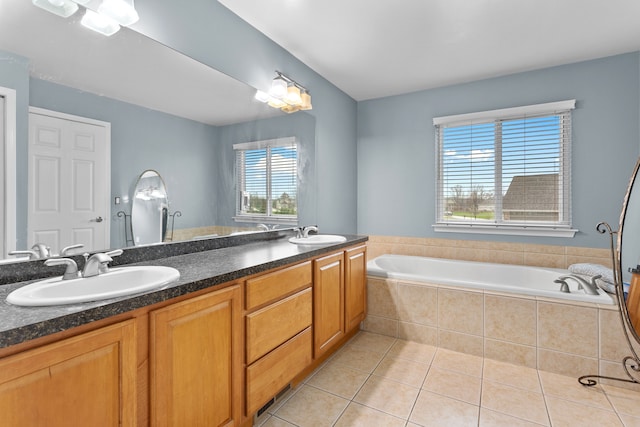 316 Lenox Ln, Brighton, MI 48114 - bathroom featuring tile patterned flooring, double vanity, a garden tub, and a sink