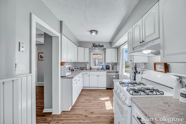 kitchen featuring white cabinets, white appliances, and under cabinet range hood