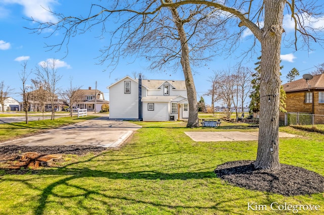 exterior space with fence and a lawn
