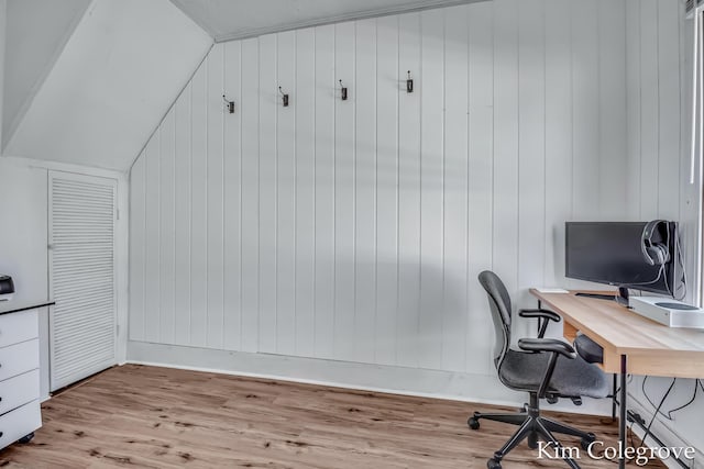 office area with wood finished floors, baseboards, and lofted ceiling